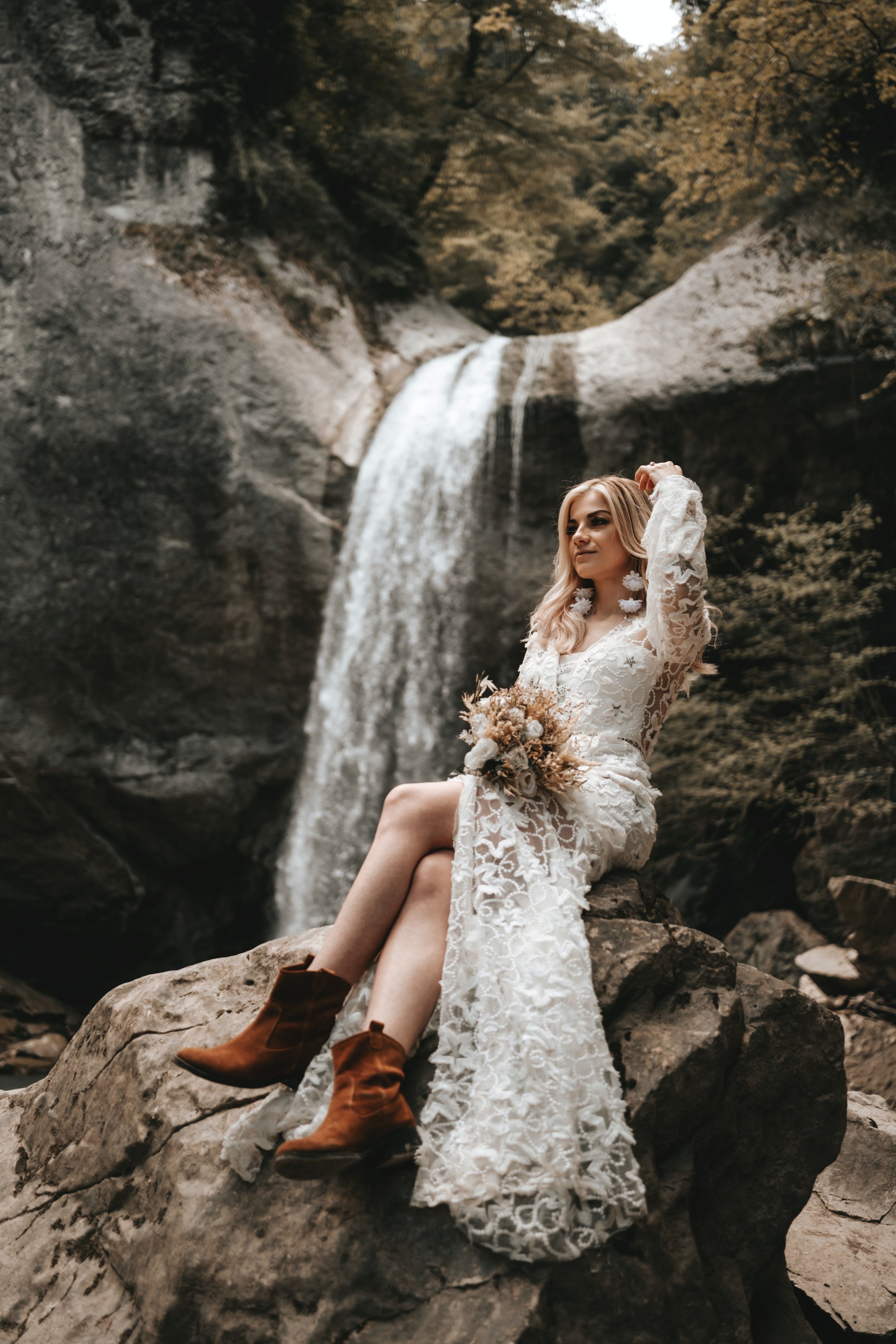 Bohemian bride wearing lacy dress and boots.